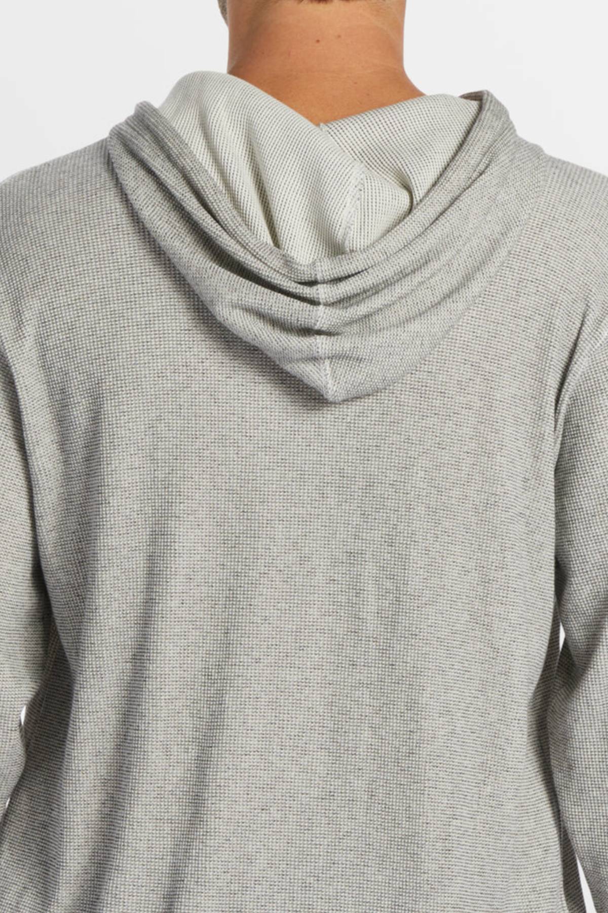 The back view of a person wearing the Billabong Keystone Pullover in light gray, featuring waffle knit thermal fabric and a hooded neck with the hood down, highlighting the textured detail.