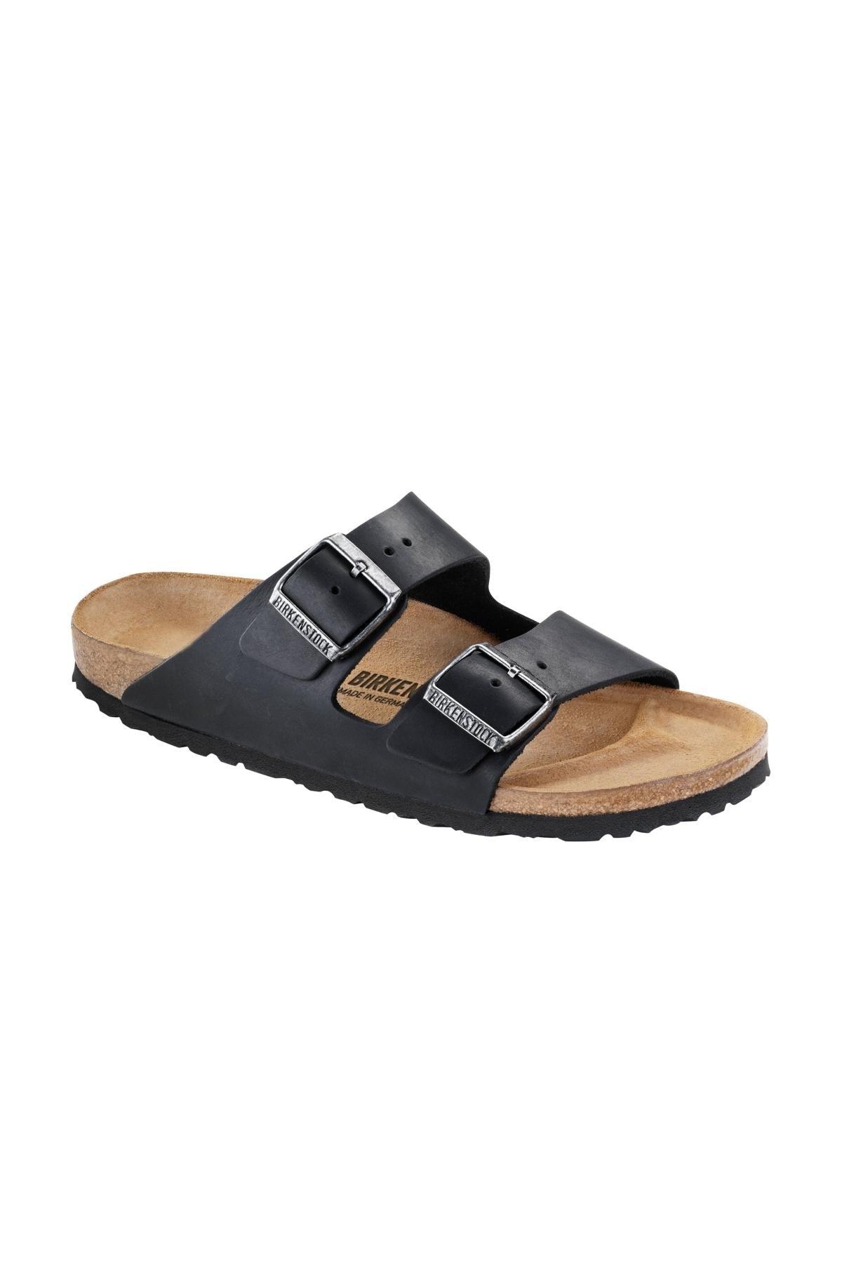 The Birkenstock Arizona is a black slide sandal with two adjustable buckles on the strap and a cork footbed with a textured sole. This sandal boasts a minimalist design and looks comfortable for casual wear.