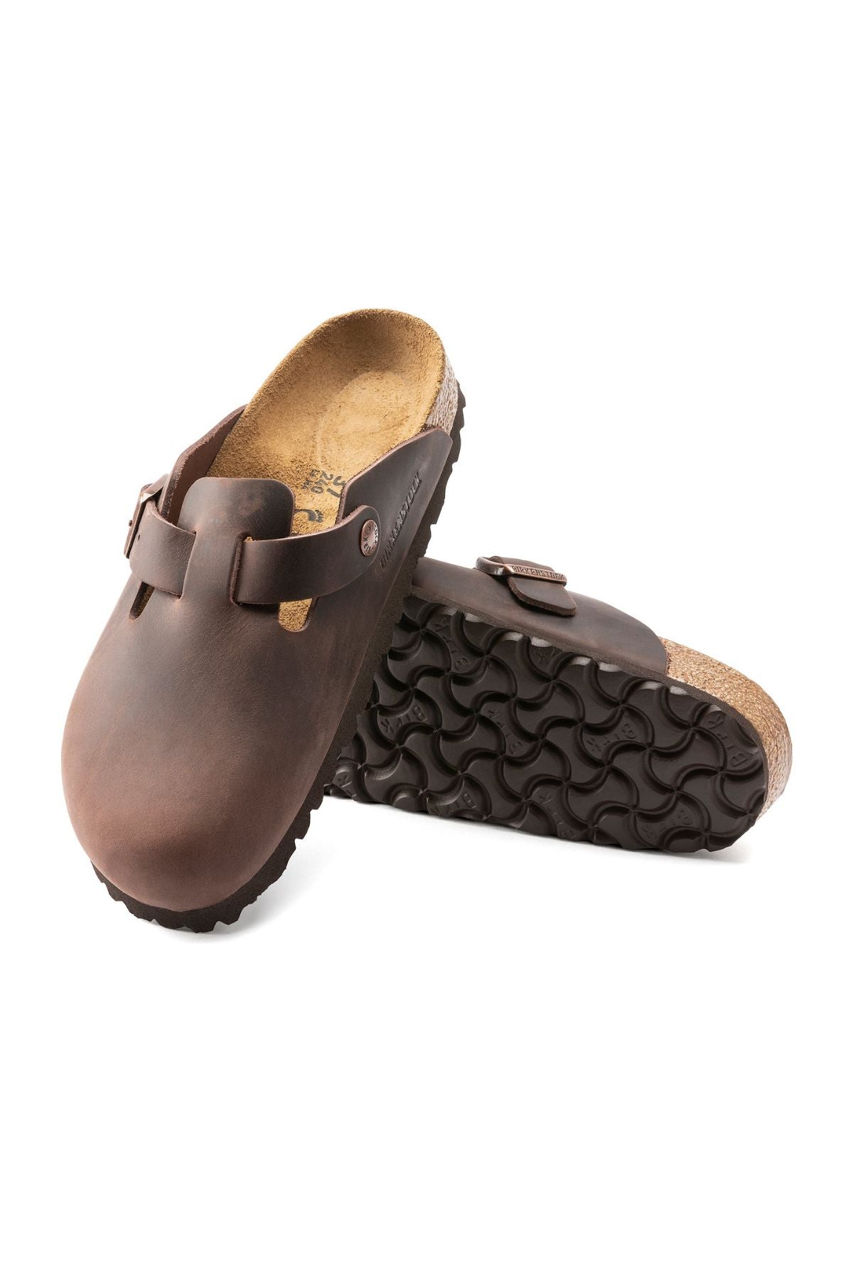 A pair of Birkenstock Boston brown leather slip-on clogs—one upright to show the textured black sole, the other lying flat to display the anatomically shaped footbed, top, and side.