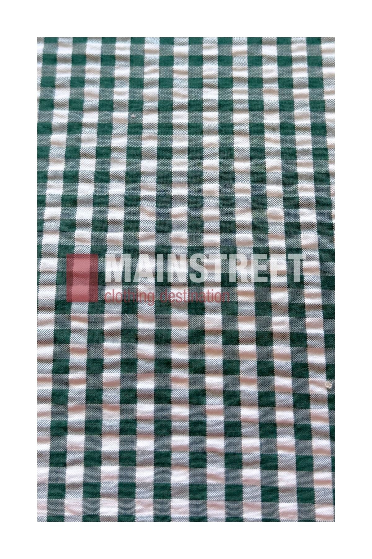 A green and white checkered fabric, inspired by the Bisley Countryman Seersucker Short Sleeve Shirt, featuring the words “MAINSTREET clothing destination” subtly printed in pink across the center.
