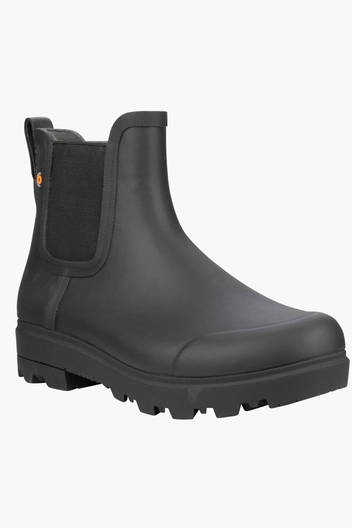 The BOGS Holly Chelsea Waterproof Boot is a black, ankle-height boot featuring elastic side panels, a back pull tab, and a thick rugged sole for traction and all-day rebound cushioning.