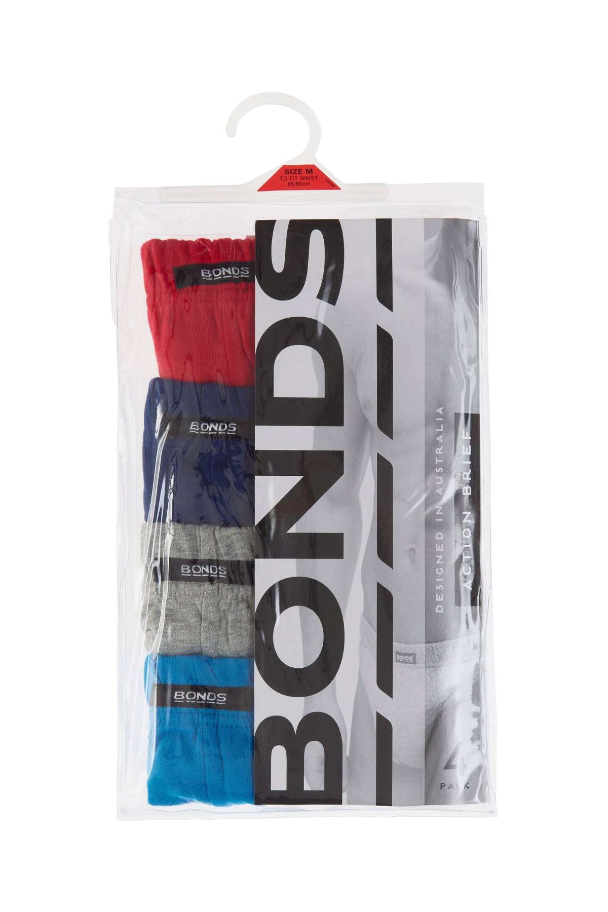 A clear plastic package contains four pairs of Bonds 4PK Action Brief in red, blue, grey, and black. The packaging displays the Bonds logo and a grayscale photo of a man modeling men's underwear.