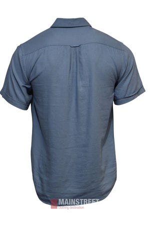 The Bridgeport Linen Blend Short Sleeve Shirt for men in light blue is shown from the back on a plain white background. This casual shirt features a straight hem and a center pleat below the yoke for added style.
