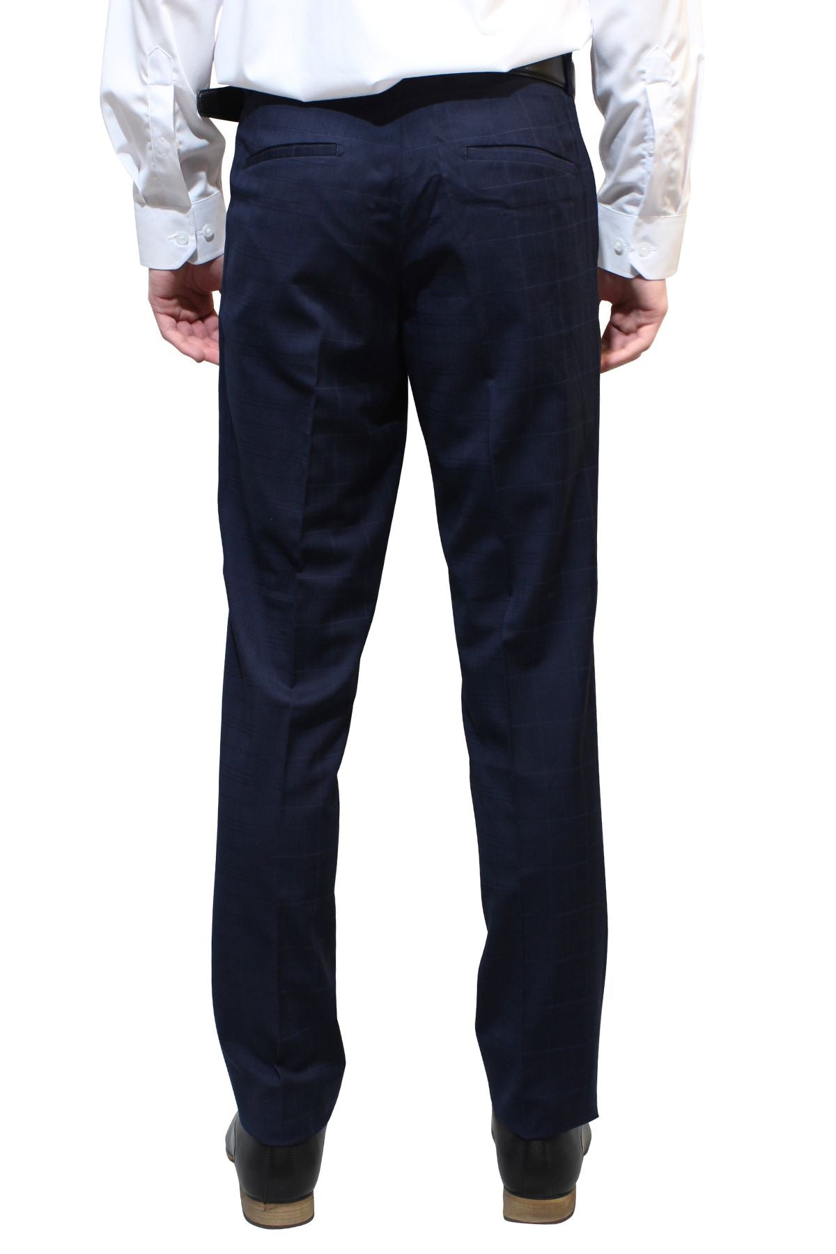 Rear view of a person dressed in dark blue Bruton Jesse Check Trousers and a white dress shirt. The individual is standing upright, with both arms hanging naturally by their sides. They are wearing black shoes, and the background is plain white.