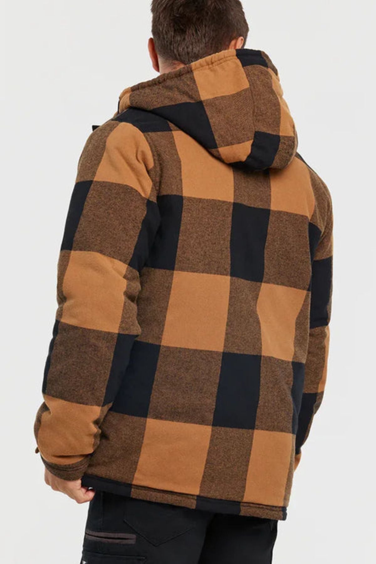 A person is seen from behind wearing a CAT Hooded Flannel Shirt Jacket with a large brown and black checkered pattern and recycled insulation, set against a plain white background.