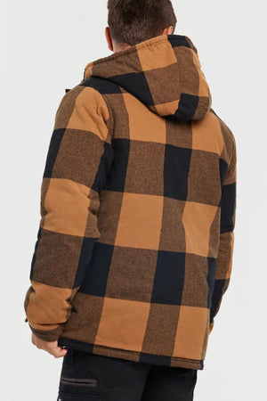 A person is seen from behind wearing a CAT Hooded Flannel Shirt Jacket with a large brown and black checkered pattern and recycled insulation, set against a plain white background.