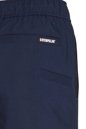 Close-up of CAT Hydraulic Short work shorts in navy blue, featuring an elastic waistband, two pockets, and a small rectangular Caterpillar logo patch above one pocket.