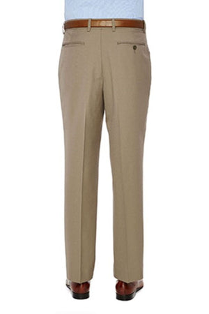 The back view of a person wearing the City Club Carter 183 Trousers, designed in stylish beige and crafted from a polyester and wool blend. The trousers feature a flexi-waist for comfort and have two rear welt pockets, one with a button closure. Paired with a leather belt, light blue tucked-in shirt, and brown dress shoes for an elegant look. The person is standing against a plain white background.