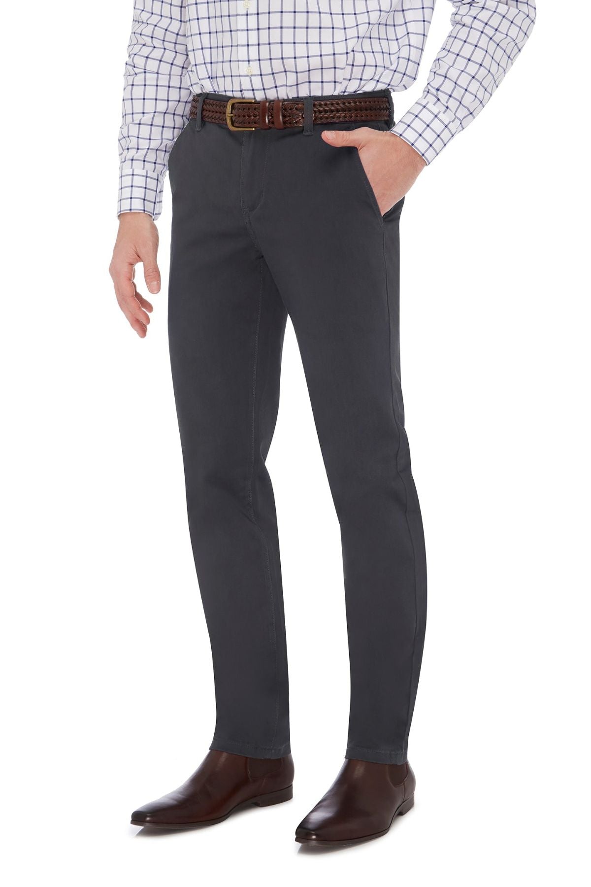 A person is standing with one hand in their pocket, wearing a white checkered shirt, brown belt, and the City Club Hammond Place Pant paired with brown leather shoes. The image captures the City Club vibe from mid-thigh down to the shoes.