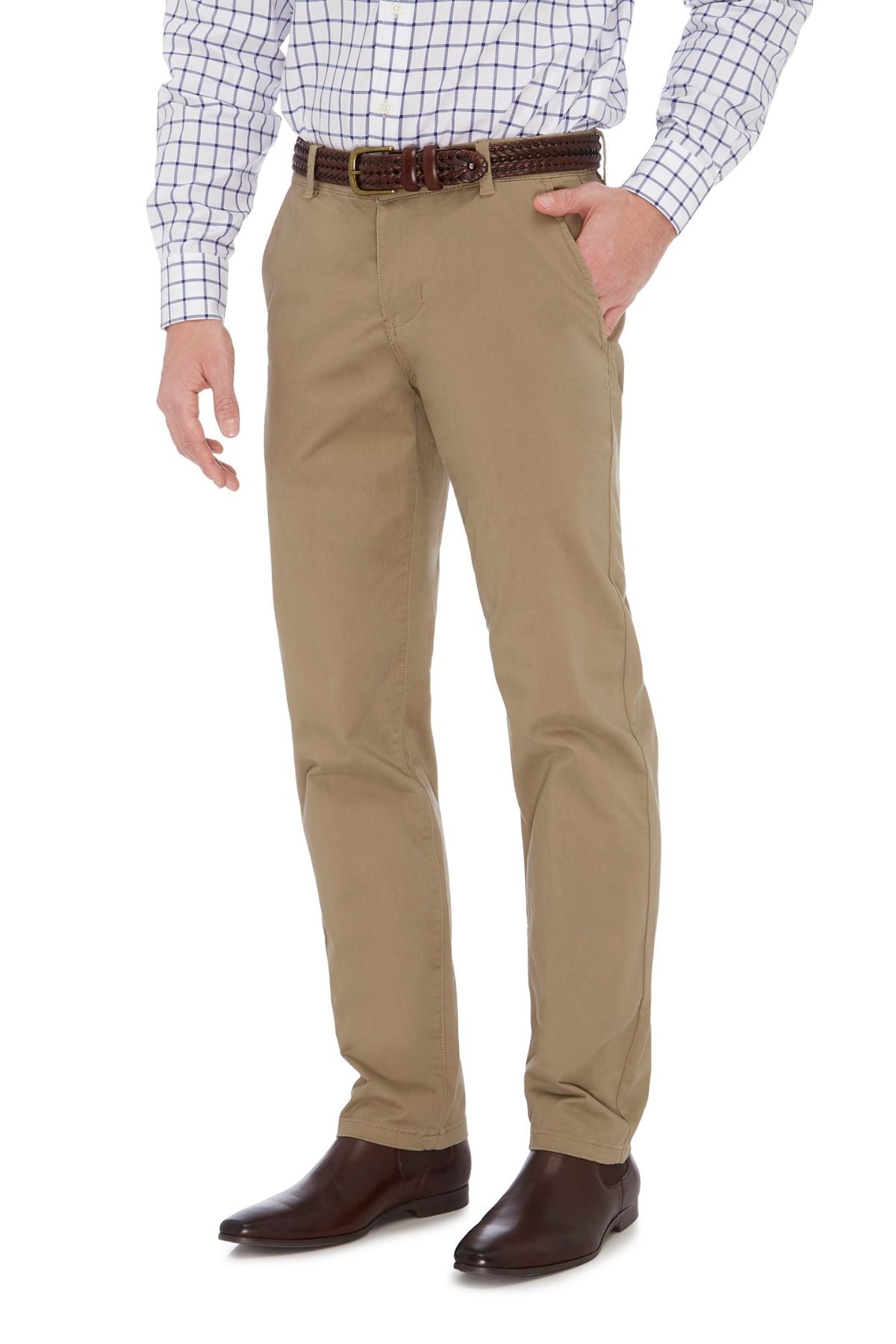 A man wearing slim fit beige City Club Hammond Place Pant, a white dress shirt with blue checks, a dark brown braided belt, and brown dress shoes. He has one hand in his pocket, standing against a white background.
