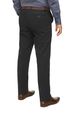 A man is shown from the back wearing a blue long-sleeve shirt, City Club Mariner Harbour Pant with elasticated sides, a brown belt, and brown dress shoes. His left arm hangs by his side while his right arm is slightly bent. The background is plain white.