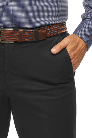 A person wearing a blue checkered shirt tucked into a pair of City Club Mariner Harbour Pants with elasticated sides. The dark pants, held up by a multicolored, braided fabric belt featuring brown leather accents and a silver buckle, fit perfectly with a hand casually resting in their pocket.