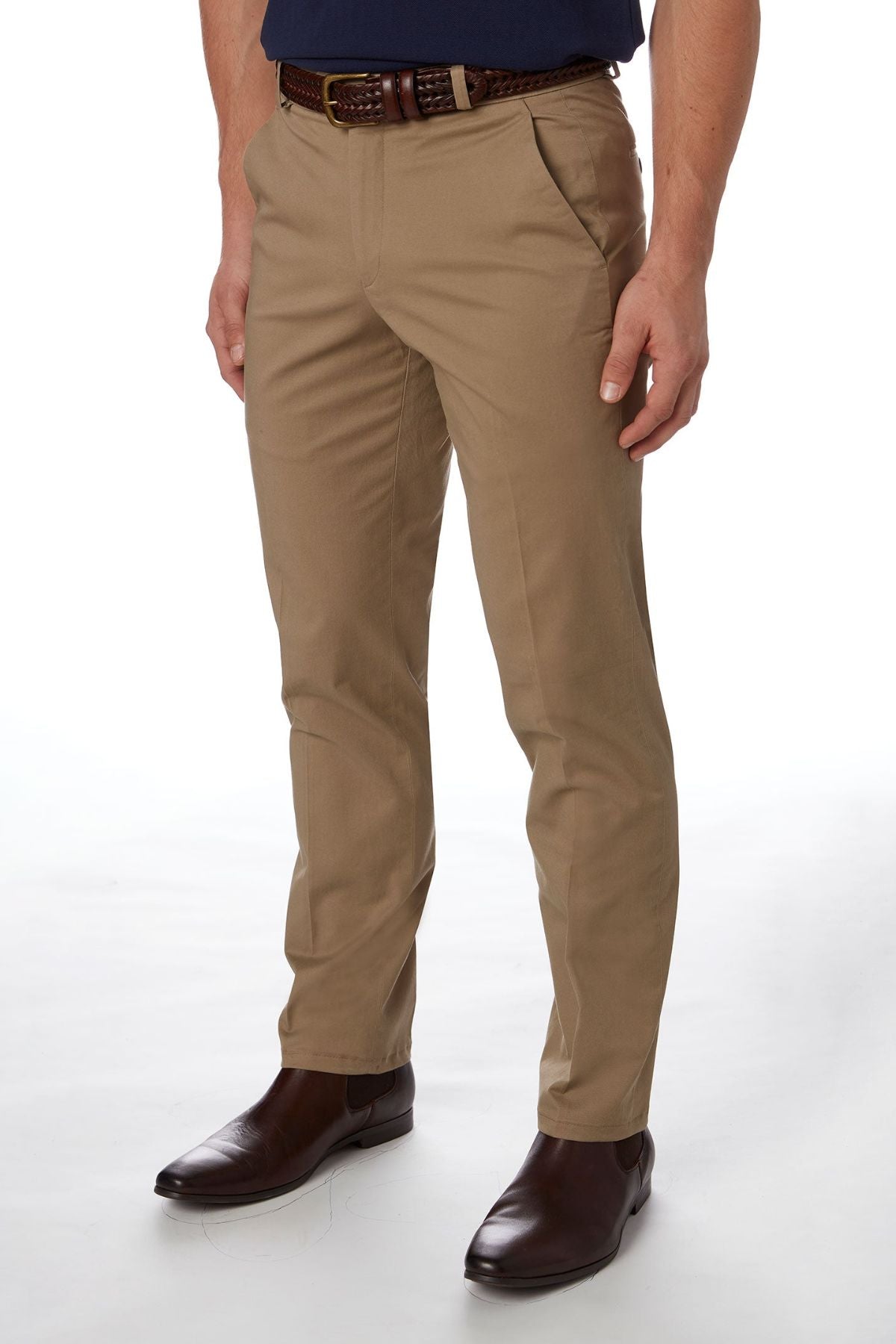 A person wearing the City Club Navigator 1770 slim fit khaki dress pants, paired with a dark brown leather belt and dark brown dress shoes. The person is standing against a plain white background, with their upper body not visible in the image.