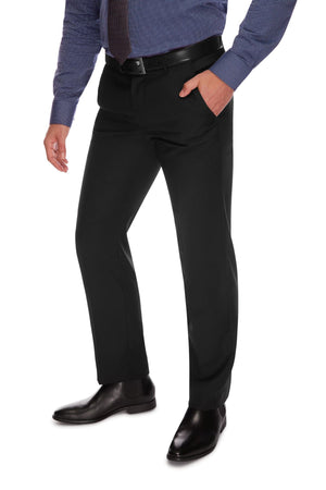 A person wearing City Club SHIMA 1007 pants with a comfortable fit, a blue striped dress shirt, a brown tie, and black dress shoes stands with one hand in their pocket. The photo shows the individual from the shoulders down against a white background.