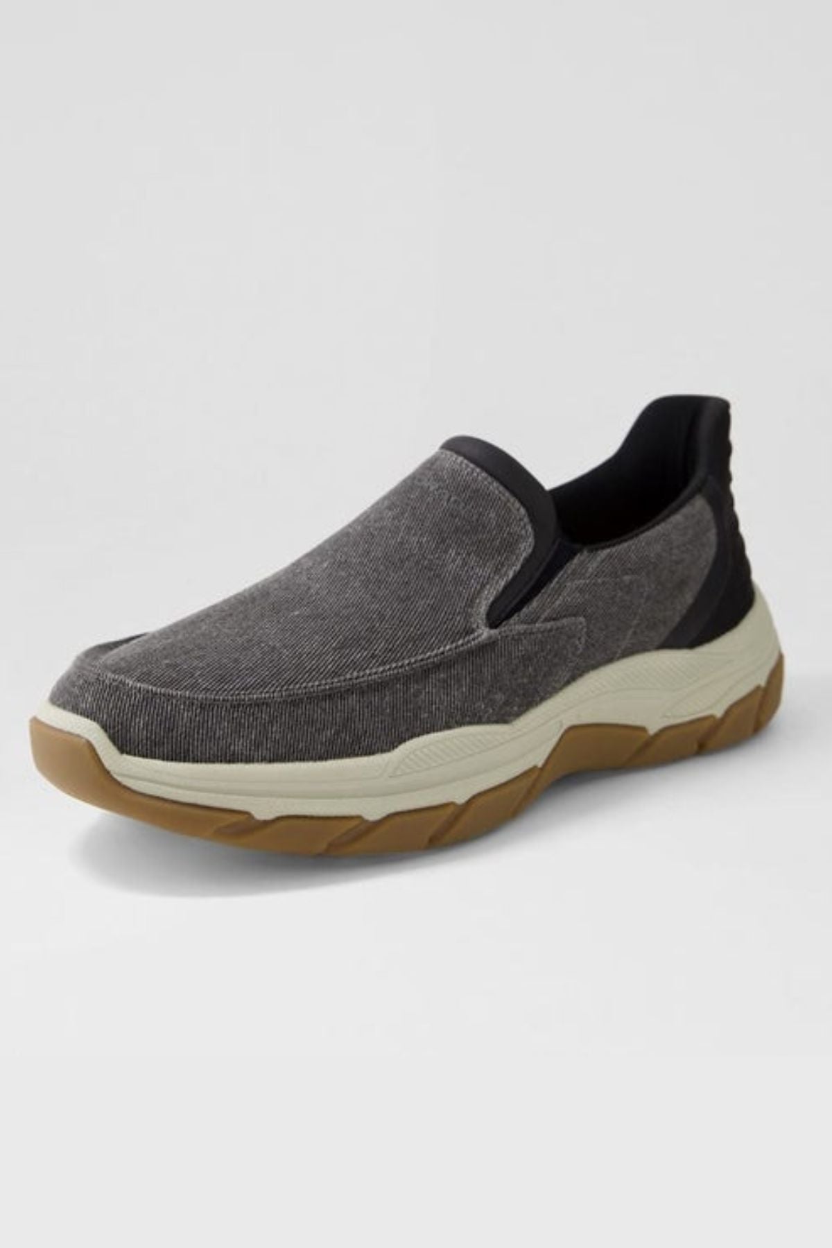 The Colorado Kanza Canvas Shoe is a gray slip-on with a black collar, visible stitching, and a thick, off-white and tan slip-resistant rubber sole, shown on a plain light background.