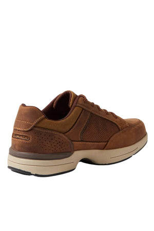 The Colorado Reach Lace Up Shoe is a brown casual sneaker featuring suede and mesh panels, a lace-up front, and a beige slip-resistant sole. The brand name appears stitched on the heel, with the shoe displayed at an angle showing the side and back.