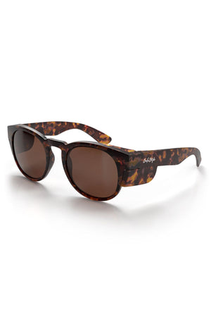 The SafeStyle Cruisers feature a matte brown tort frame with thick, round brown polarised lenses. The white brand logo appears on the left temple. These sunglasses provide UV400 protection and are shown on a white background.