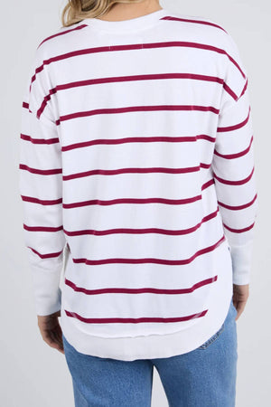 A person is shown from the back wearing a relaxed fit Foxwood Farrah Stripe Long Sleeve with soft Pima Cotton and horizontal red stripes, paired with blue jeans.