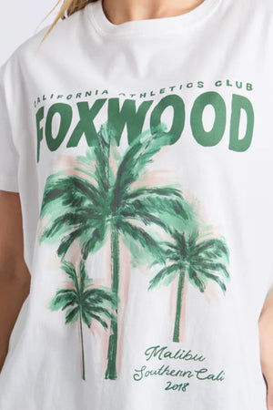 Wearing the Foxwood Malibu Tee, a relaxed fit white cotton t-shirt featuring green "FOXWOOD" text, palm trees, and "California Athletics Club," "Malibu Southern Cali 2018" prints.