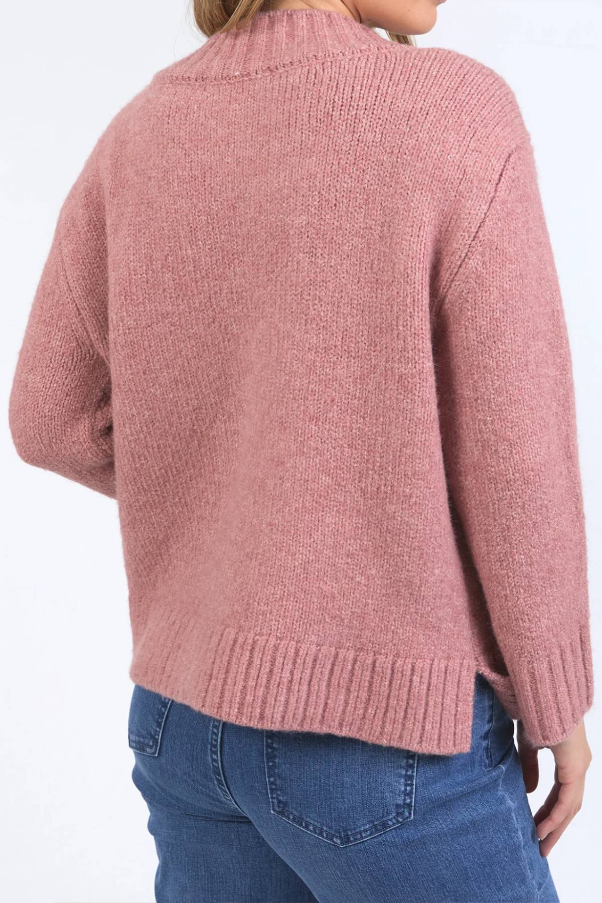 A person wearing the Foxwood Pepper Knit sweater in pink with blue jeans, shown from the back against a plain light background.