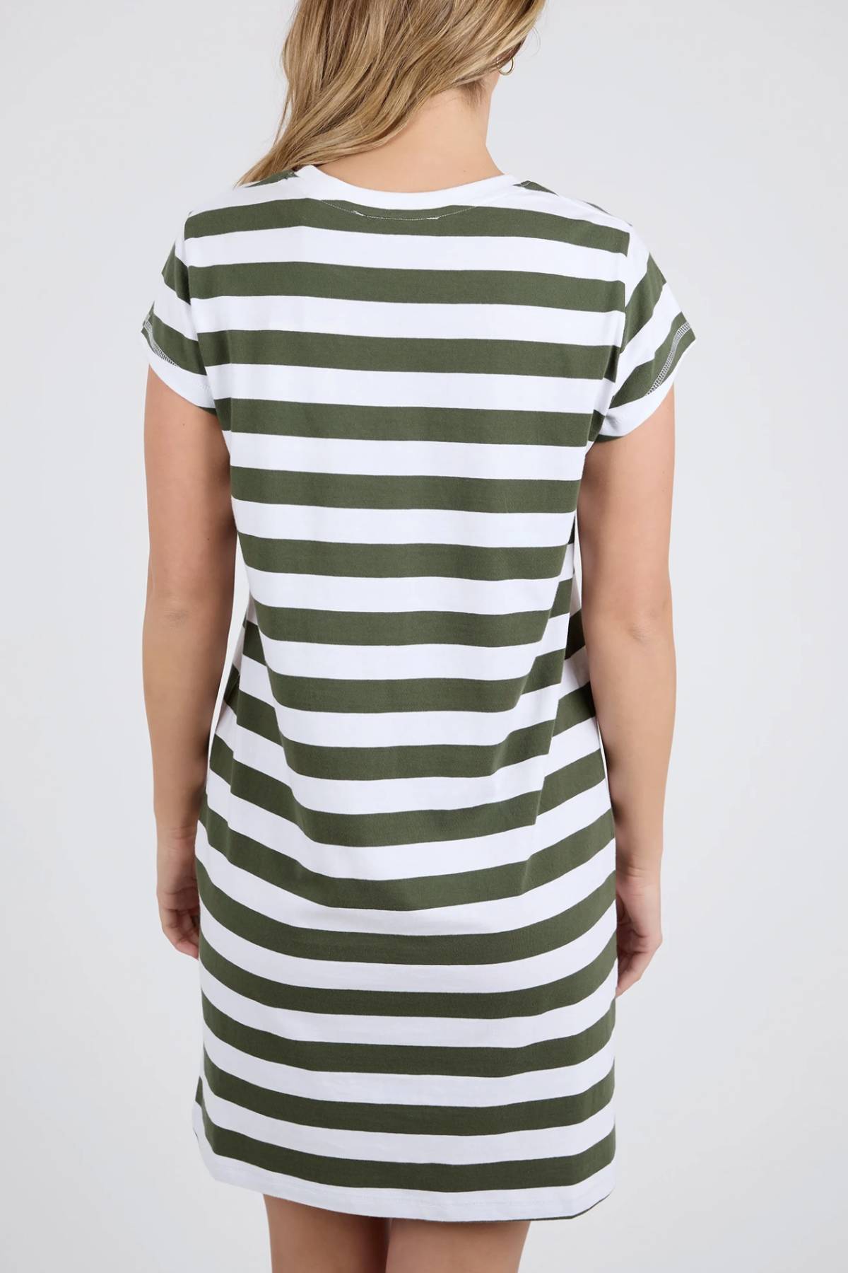 A person with light brown hair is seen from behind, wearing the Foxwood Signature Stripe Tee Dress. This short-sleeve 100% cotton dress has horizontal green and white stripes and appears against a light background.