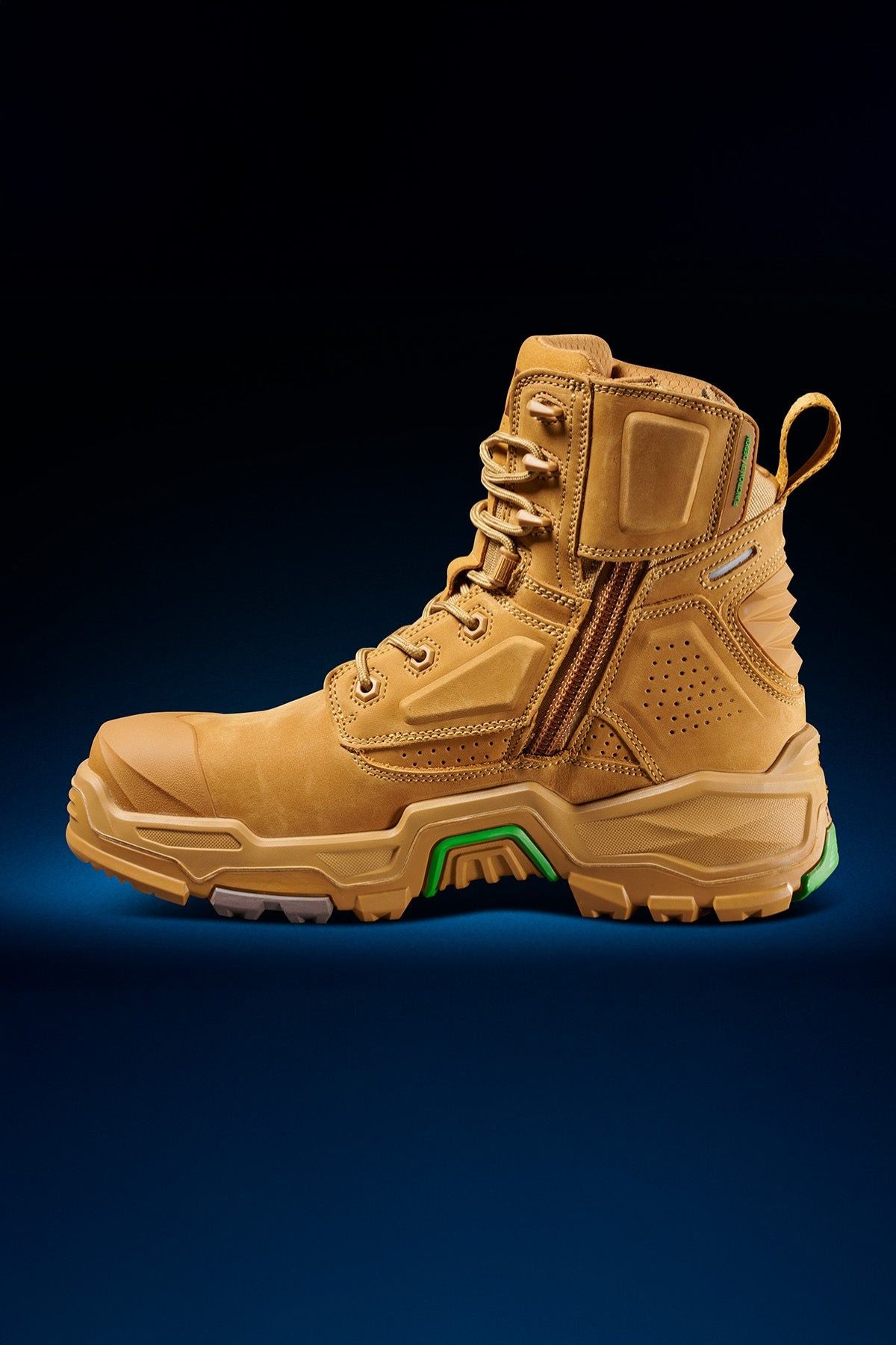 The FXD Dura X-1 Nitrocore™ High Cut, High Performance Work Boots feature tan uppers, green accents, a side zipper, and thick treaded soles, shown against a dark blue gradient background.