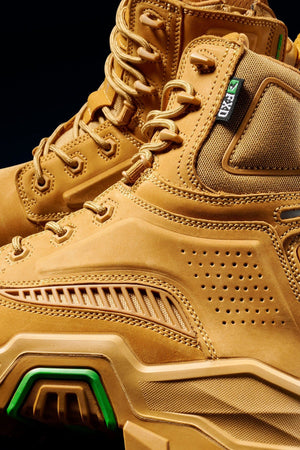 Close-up of FXD Dura X-1 Nitrocore™ High Cut, High Performance Work Boots with detailed stitching, perforated panels, thick textured soles, green accents, and rugged laces highlighted against a dark background.