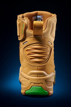 The FXD Dura X-1 Nitrocore™ High Cut, High Performance Work Boots are shown from the back in tan and green, featuring textured panels, a heel pull tab, and a sturdy sole against a dark blue gradient background.