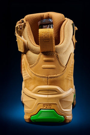 FXD Dura X-2 Nitrocore™ Mid Cut High Performance Work Boot shown from the back, with a padded collar, green-accented sturdy sole, textured details, and heel pull tab, set against a dark gradient background.