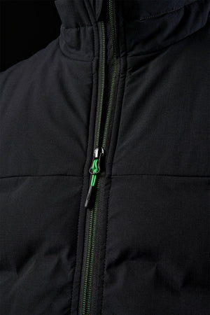 Close-up of the FXD WO-6 Insulated Puffer Vest showing its green and black zipper, vertical stitch lines, and padded performance fabric that highlights the texture and details of the front.