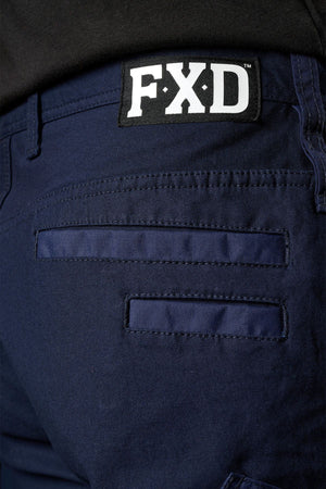 Close-up of the back pocket area on navy blue FXD WP-3L Loose Fit Stretch Canvas Work Pants, showcasing a black and white “FXD” logo patch on the waistband.