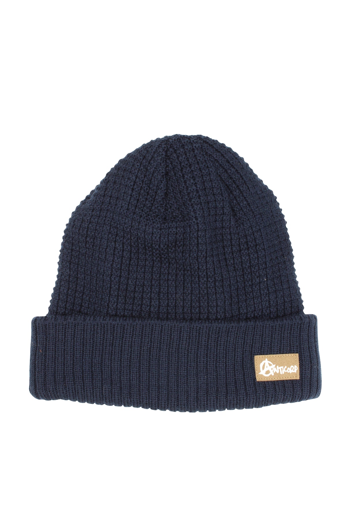 The Anticorp Grid Lined Beanie is dark blue with a folded contrast knit roll cuff, featuring a small brown patch with stylized white lettering on the cuff. Its ribbed texture and fleece lining give it a thick, warm feel, ideal for chilly days.