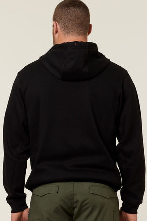 A person is standing with their back to the camera, wearing a black Hard Yakka Plain Fleece Hoodie, featuring a hood and long sleeves, paired with green pants. The background is plain and light-colored.