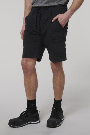 A man wearing Hard Yakka X Range Mid Shorts, crafted from durable black Cordura nylon.