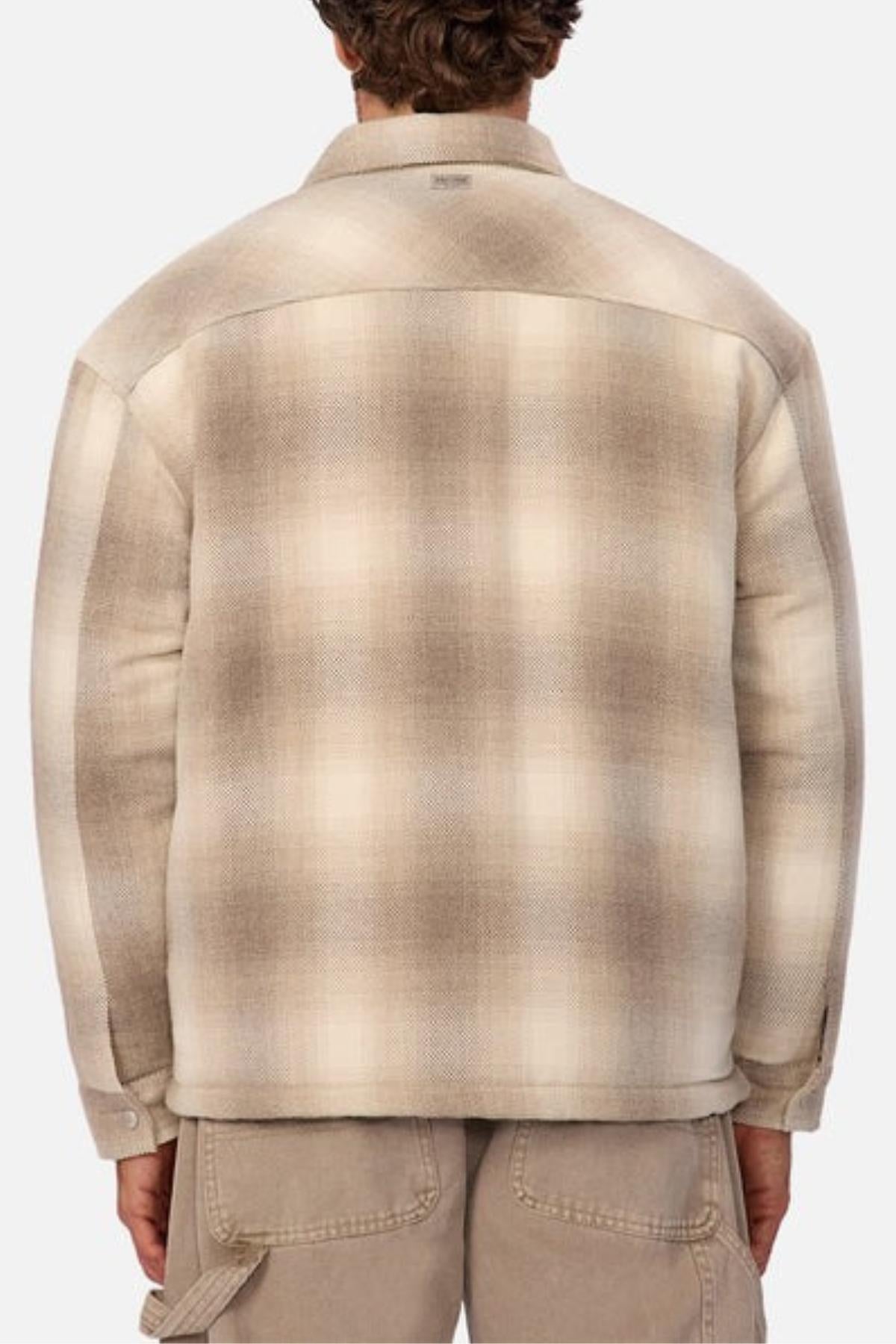 A person is shown from the back wearing the Industrie The Highland Jacket in beige and brown plaid with long sleeves and khaki pants. They appear ready for an adventure against a plain, light-colored background.