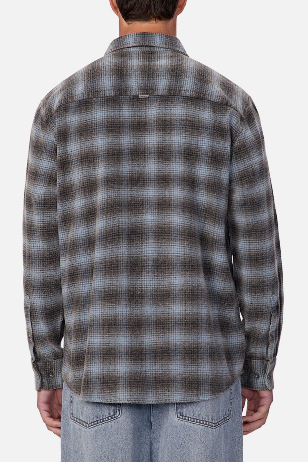 Someone is shown from the back against a plain, light background, wearing the Industrie Durango Long Sleeve Shirt in blue and gray plaid cotton with light blue jeans—perfect for everyday wear.