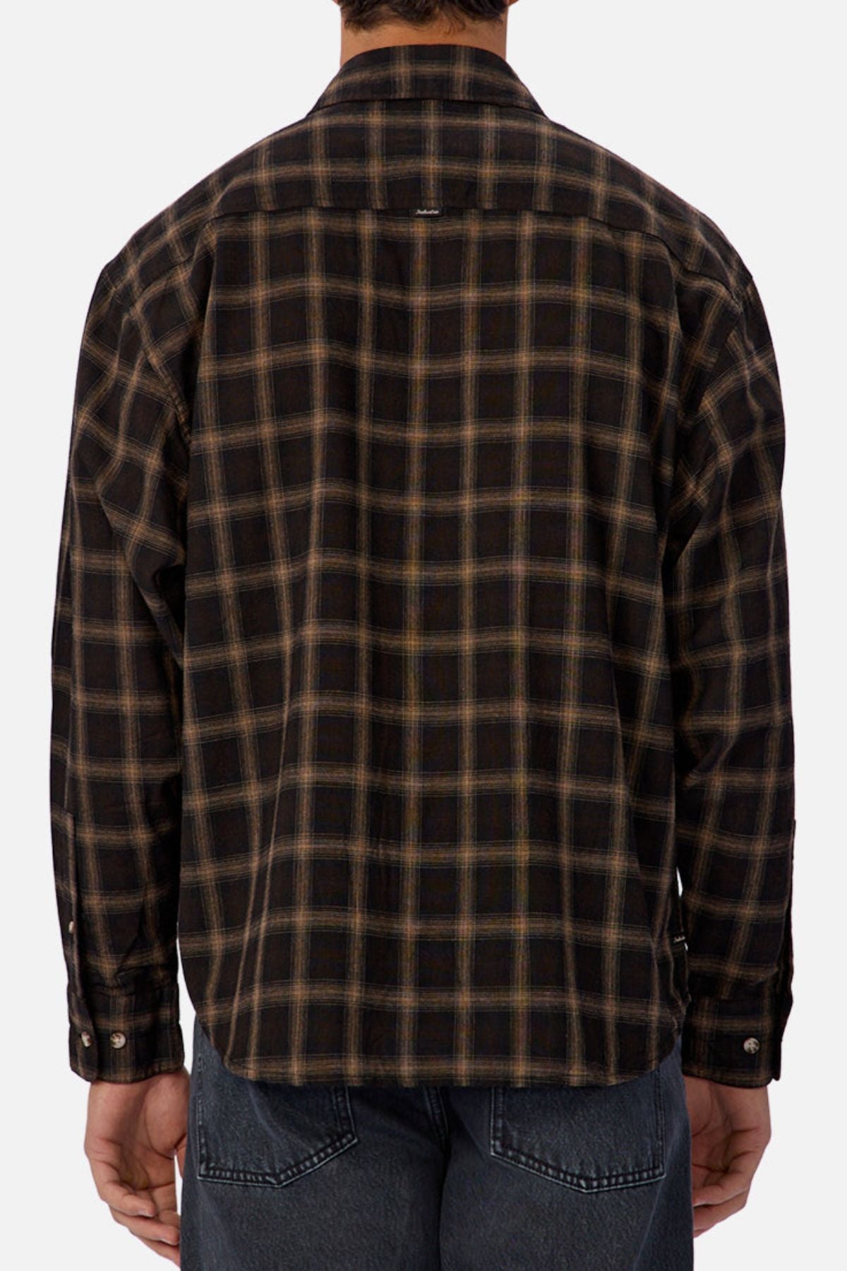 A person is shown from the back wearing the Industrie The Carrington Shirt, a regular fit, long-sleeve dark brown and black checked shirt, paired with dark denim jeans.