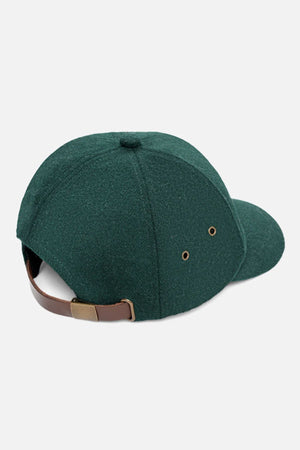 The Industrie The Claude Cap is a dark green wool blend cap with an adjustable brown leather strap, brass buckle, and two side eyelets for ventilation. Shown from the back.