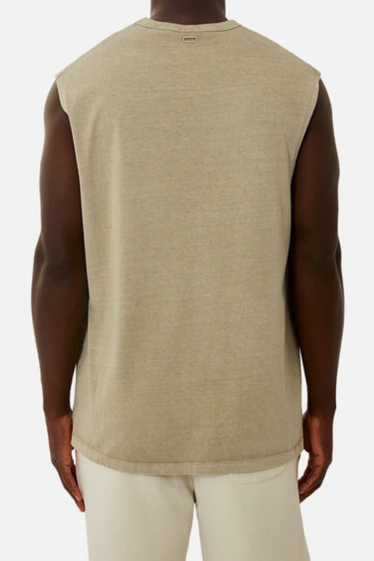 A person is wearing the Industrie The Del Sur Sleeveless Tee, which features an oversized fit in beige and is made from 100% cotton, along with light-colored pants. The outfit is displayed from the back against a plain white background.