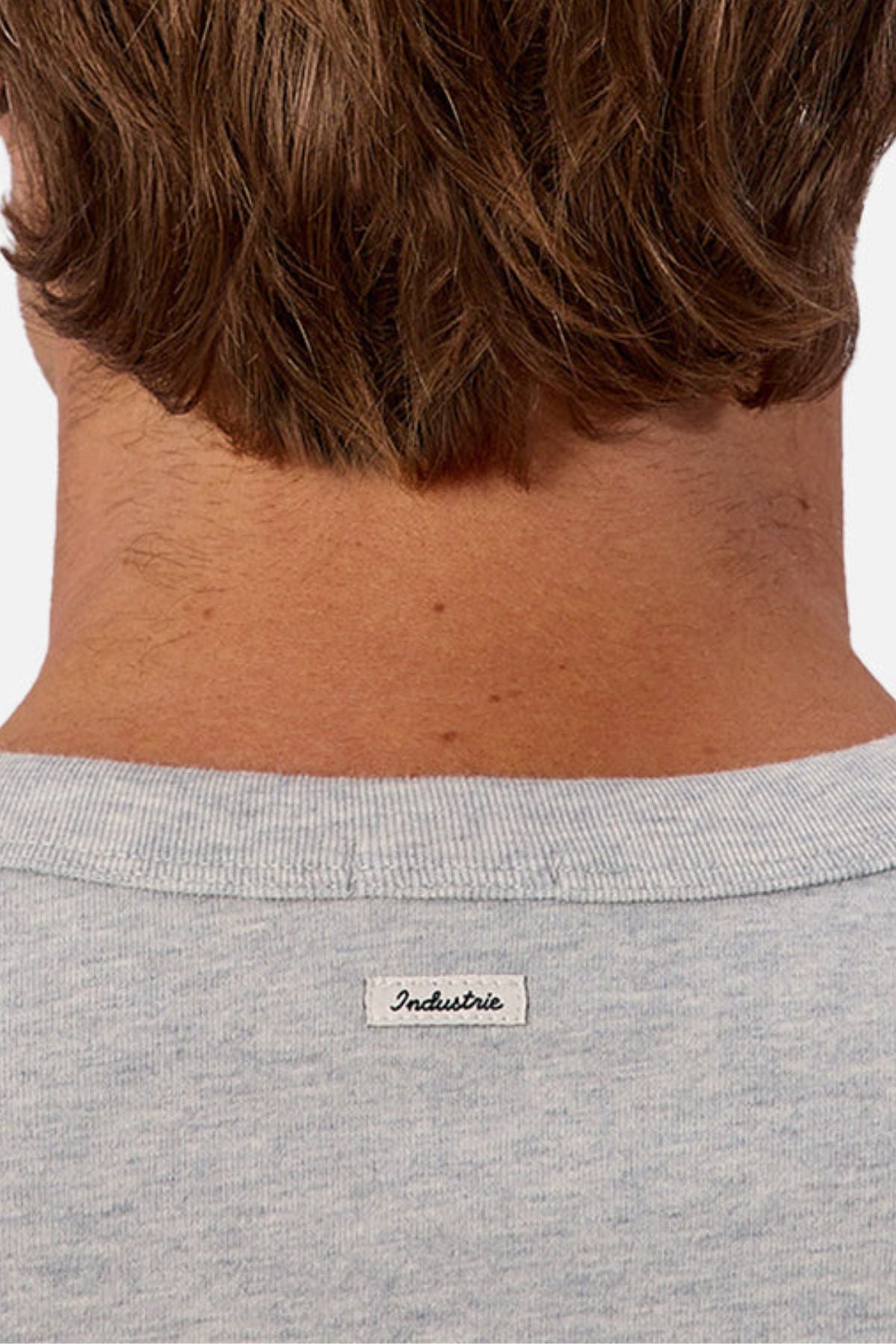 Close-up of the back of a person’s neck and head with light brown hair, wearing the gray Industrie The Del Sur Tee. A small white "Industrie" label is visible, showcasing the tee’s distinct oversized fit.