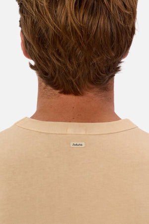 View from behind of a person with light brown hair wearing an oversized Industrie The Del Sur Tee crafted from heavyweight fabric. A small label is visible on the back of the shirt, set against a plain white background.