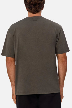 A person with short curly hair is seen from the back, wearing the Industrie The Freeman Athletic Tee in dark gray and black pants against a plain light background.