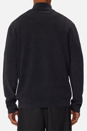 A person is shown from the back wearing Industrie The Lakewood Zip Neck, a plain, long-sleeved black cotton jumper with black pants. The relaxed, regular-fit outfit is set against a white background.