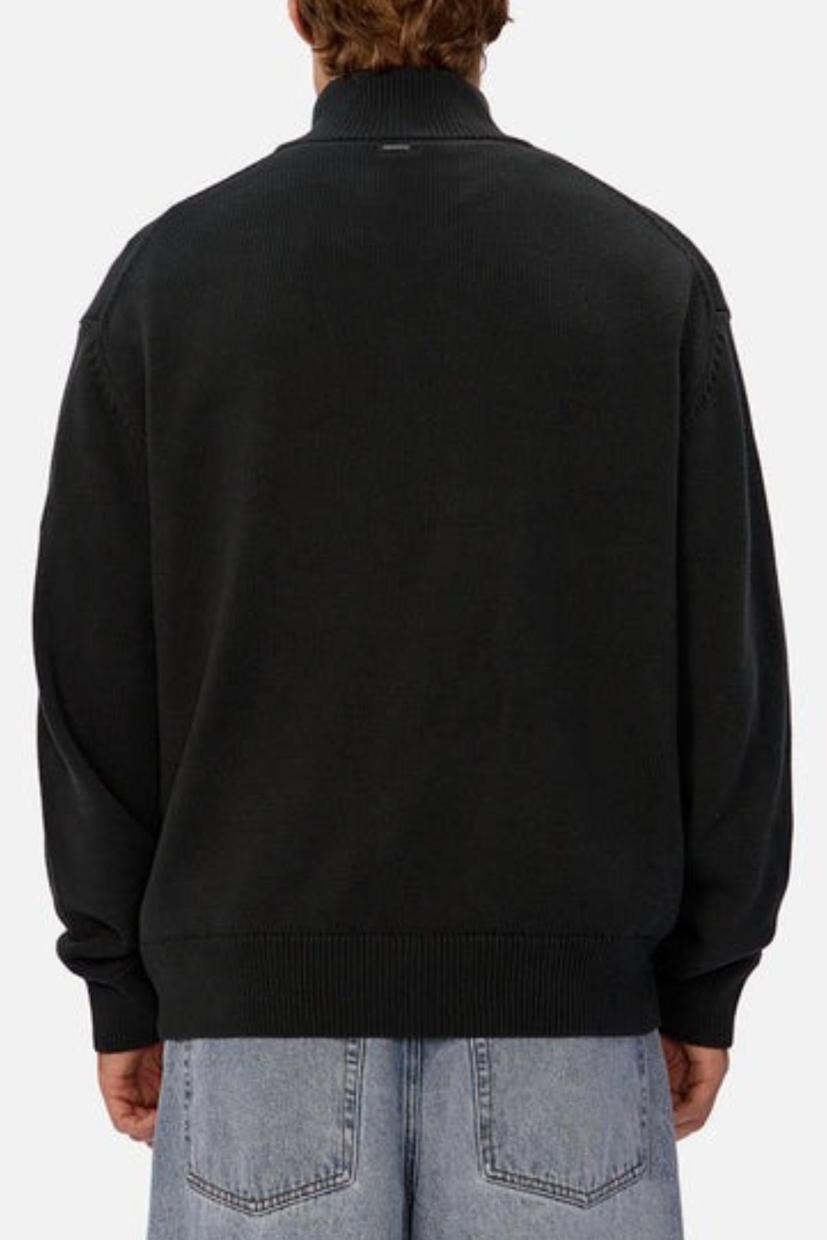 A person is shown from behind wearing the Industrie The Maine Zip Neck Knit in black with light blue denim jeans against a plain, light-colored background.