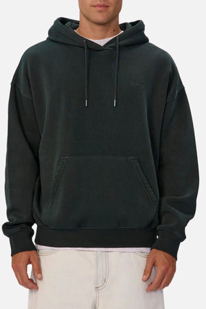 Someone wearing the Industrie The New Del Sur Washed Hoodie, featuring a front pocket and drawstrings, pairs it with light-colored pants while standing against a plain light background.