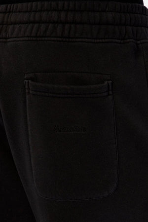 Close-up of the back pocket on the Industrie The New Del Sur Washed Trackpant, a black sweatpant featuring a drawstring waist, elastic waistband, subtle logo detailing on the pocket, and elasticated cuffed ankles.