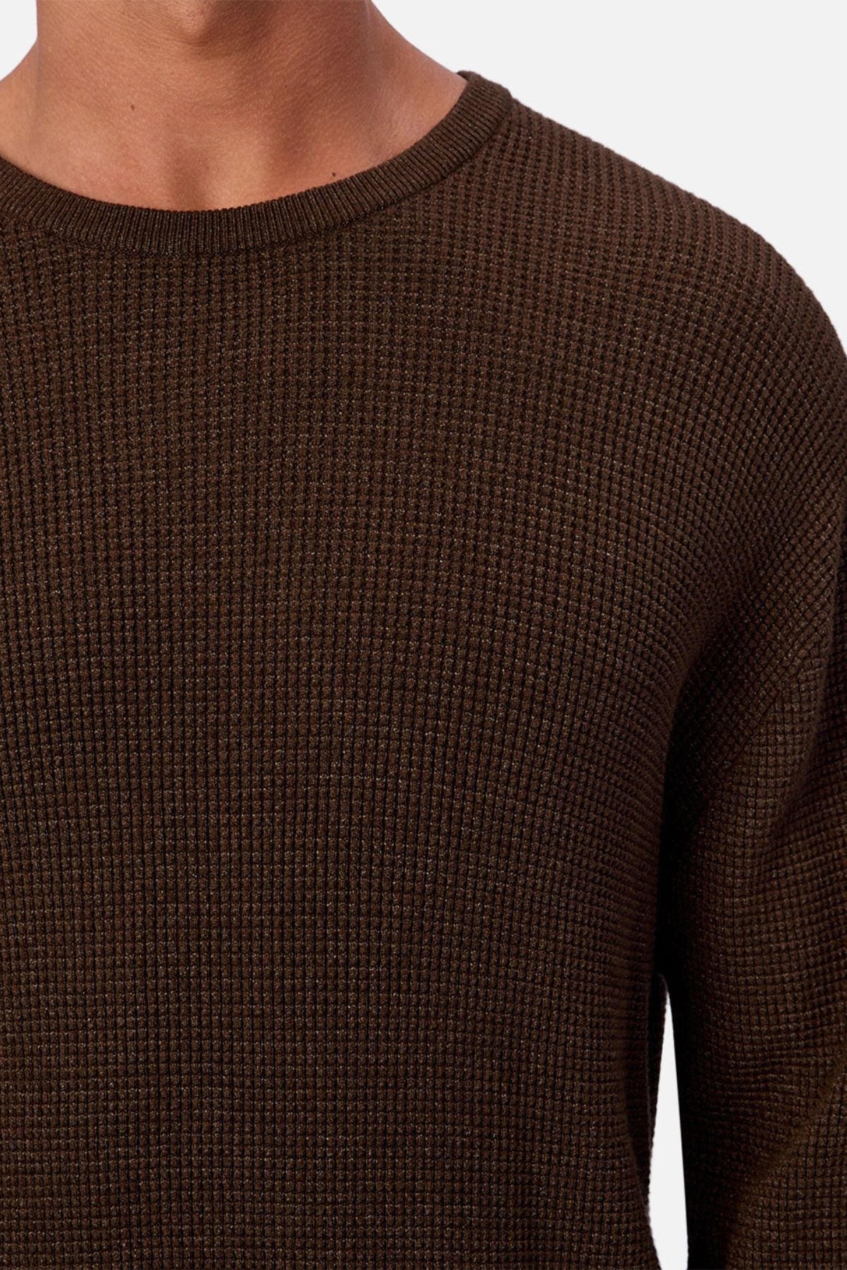 Someone wears the Industrie The Philly Waffle Knit, a textured dark brown men's crew neck sweater shown from shoulders to mid-chest against a plain white background.