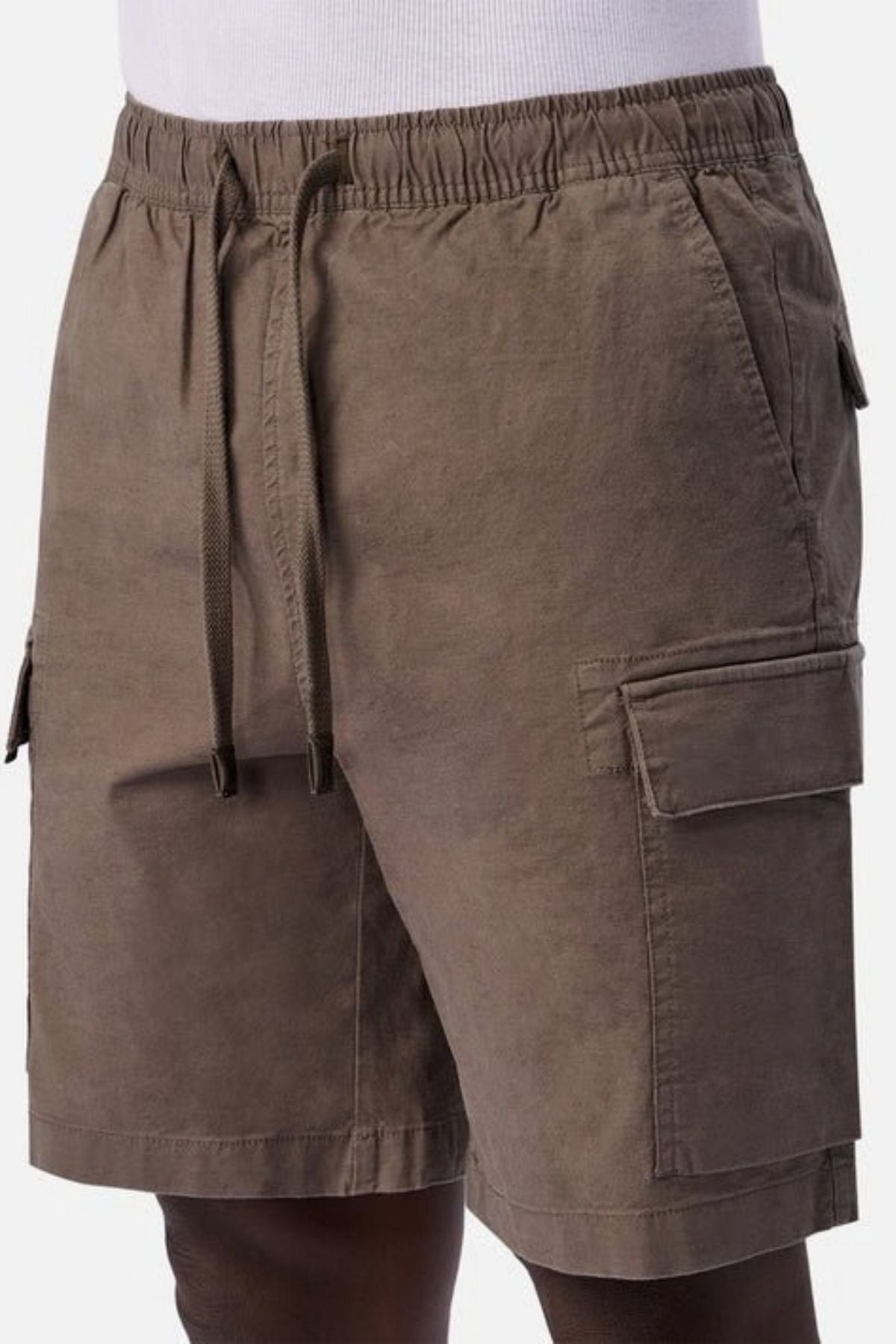 A person is shown from the waist to mid-thigh wearing Industrie The Platoon Combat Short in brown, featuring an elastic waistband with a drawstring, side pockets, and flap pockets.