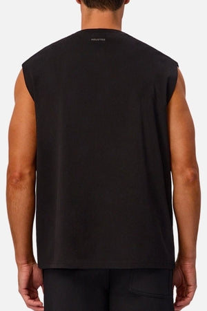 A man faces away from the camera wearing the Industrie The Tech Port Sleeveless Tee in black, a relaxed-fit design with βINDUSTRIEβ printed at the top center of the back. He pairs it with matching black tech shorts, all set against a plain background.
