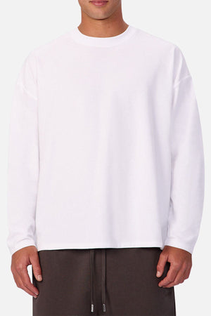 A person wears the Industrie The Waffle Long Sleeve Tee and dark drawstring pants, standing against a light background. The cropped image shows only from neck to above the knees, capturing a classic, minimalist look.
